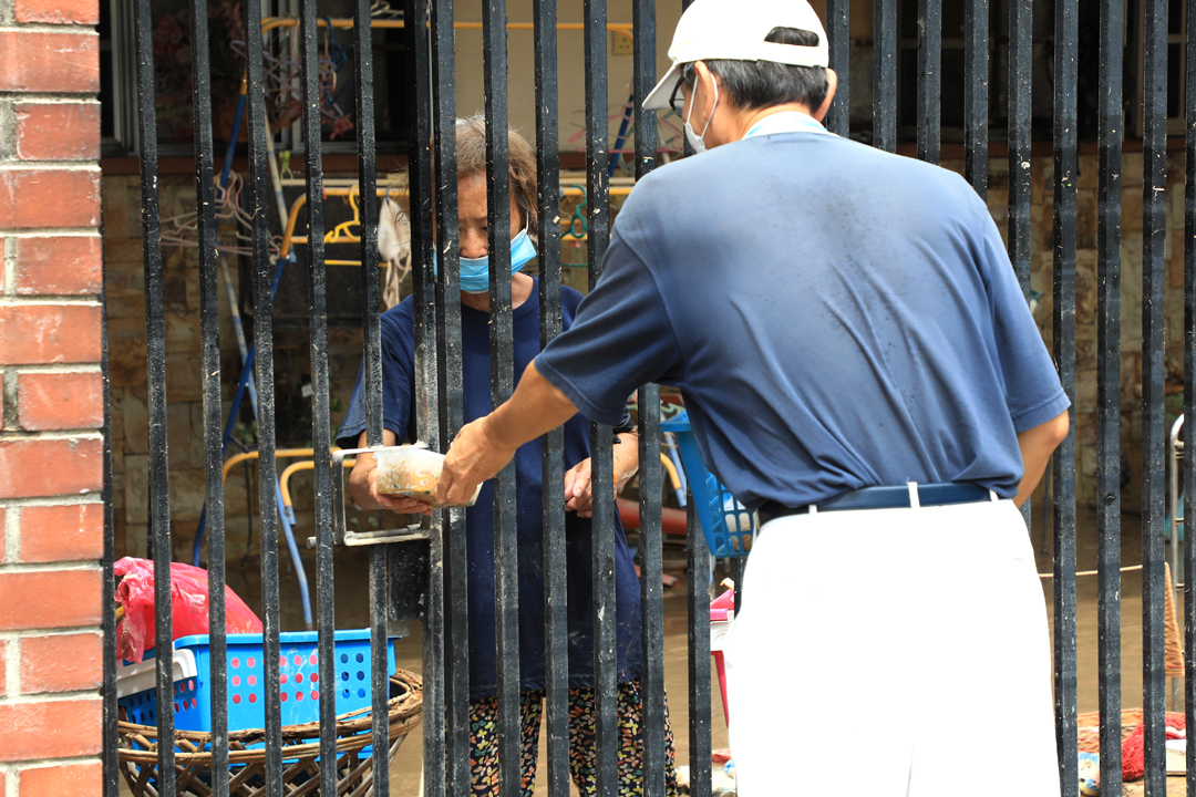  志工分成小组动员，挨家挨户询问是否有需要协助的地方。【摄影：陆福祥】