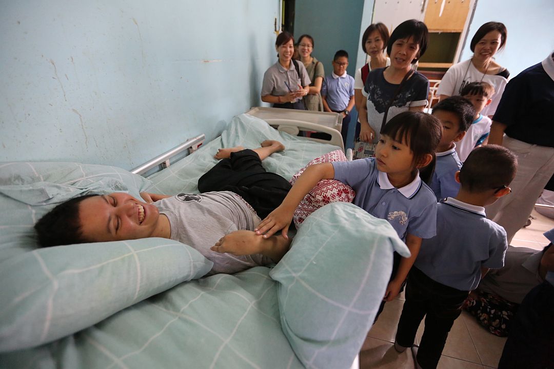 Participants of Tzu Chi Parent-Child Bonding Class in Malim visited the Happiness Centre for the Mentally Disabled Children to provide care for the inmates. Lai Jia En is seen here extending her care to an inmate. [Photograph by Yong Siew Lee]