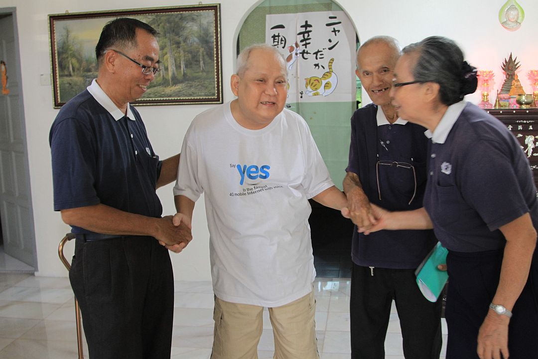 Care from fellow volunteers is Ng Chee Cheng’s (2nd from left) motivation to keep going. [Photograph by Low Siew Lian]